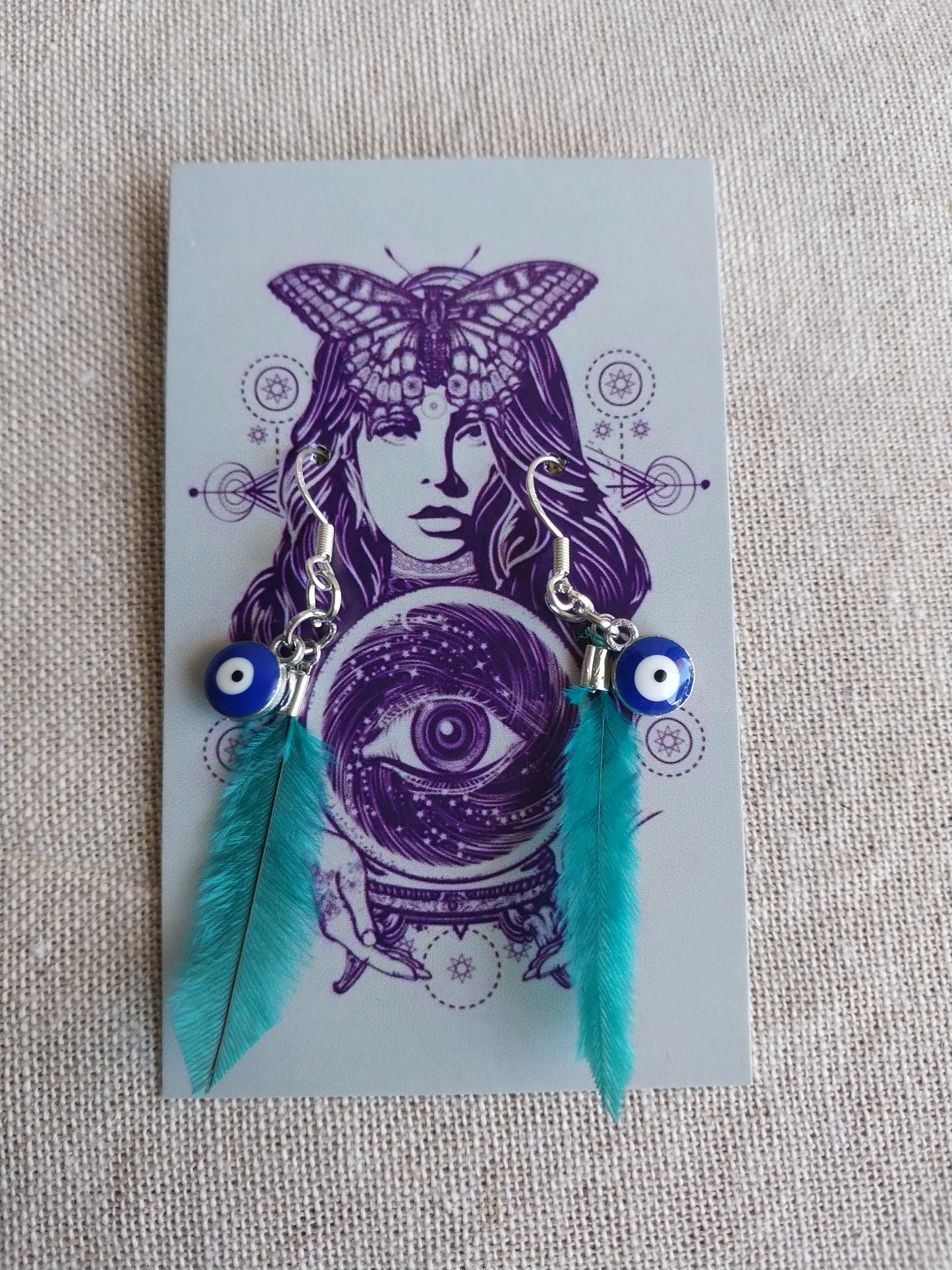 Evil eye teal feather earrings